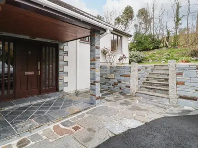 a front door of a house with a stone wall at Higher Kernick Farm in Launceston