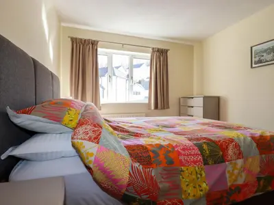 a bedroom with a bed with a colorful blanket at 12 Kel Avon in Truro