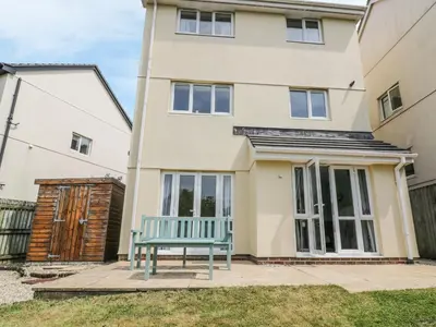 a blue bench in front of a house at 12 Kel Avon in Truro