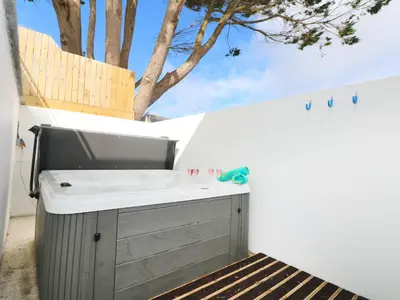 a bathroom with a sink and a tree at An Drowes in Newquay