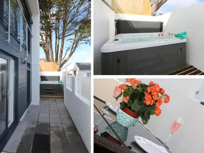a bathroom with a tub and a sink and flowers at An Drowes in Newquay