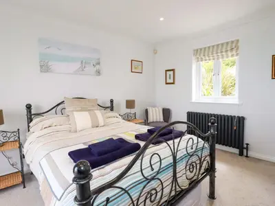 a bedroom with a large bed in a room at Pink House in Mevagissey