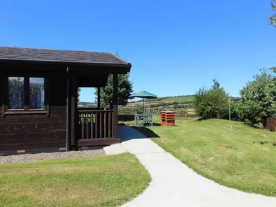 a gazebo with a path next to a park at Holly Lodge in Bodmin
