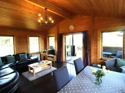 a living room with a couch and a table at Hazel Lodge in Bodmin