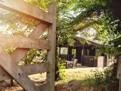 a wooden fence in front of a house at Hazel Lodge in Bodmin