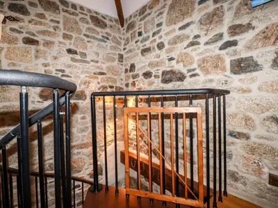 a stone wall with a staircase in a room at Sunnywell in Bodmin