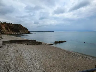 a beach with a rocky shore and the ocean at Tyack in Charlestown