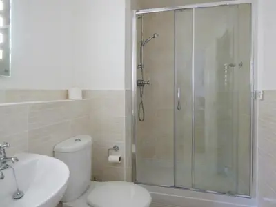 a bathroom with a shower and a toilet and a sink at Tyack in Charlestown