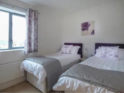 a bedroom with two beds and a window at Tyack in Charlestown