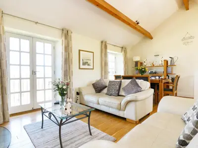 a living room with a couch and a table at Atlantic View in Tintagel