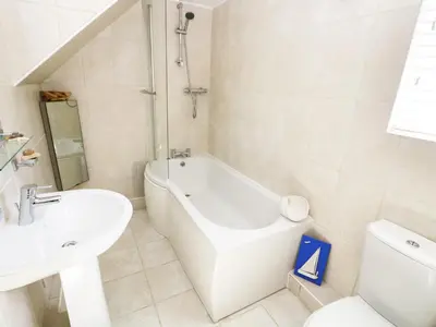 a bathroom with a tub and a sink and a toilet at Atlantic View in Tintagel