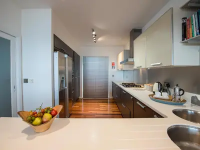 a kitchen with a bowl of fruit on a counter at Rock Rose in Downderry