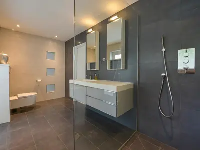a bathroom with a sink and a shower and a toilet at Rock Rose in Downderry