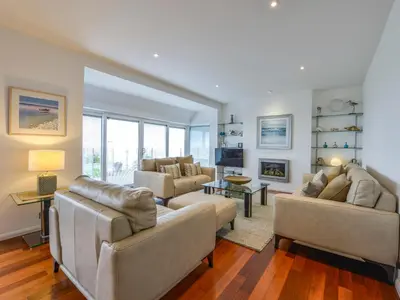 a living room with two couches and a tv at Rock Rose in Downderry