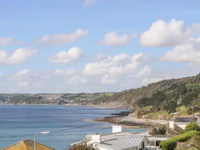 a view of a body of water with houses at Rock Rose in Downderry