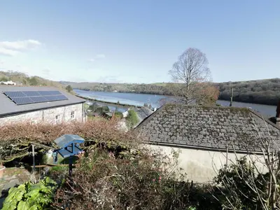 an aerial view of a house with a solar roof at Treetops in Fowey