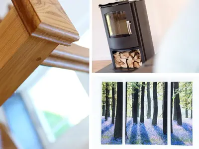 a room with a woodburning stove and a picture of a forest at Moor View Chapel in Camelford