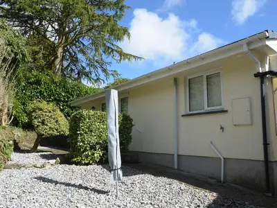 a house with an umbrella outside of it at Little Retreat in Liskeard