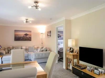 a living room with a couch and a tv at Little Retreat in Liskeard
