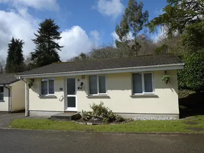a small white house with a porch at Little Retreat in Liskeard