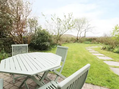 a white picnic table and two chairs in a yard at Brunnion House in Hayle