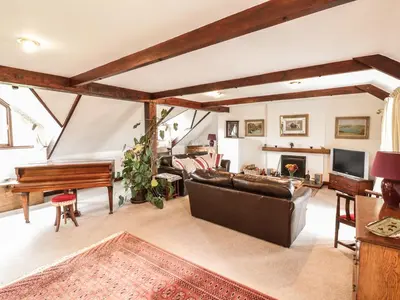 a living room with a couch and a piano at Brunnion House in Hayle