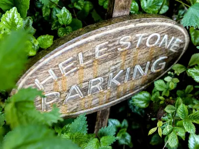 a sign with the words idealore group parking at Hele Stone Cottage in Launceston