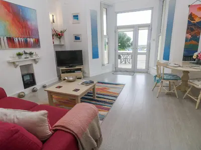 a living room with a couch and a table at Beachcomber in Marazion