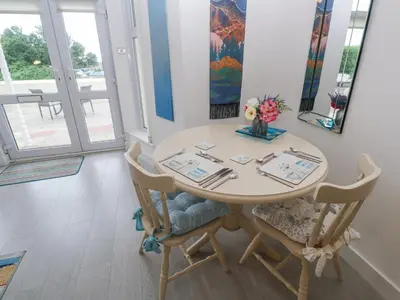 a dining room with a table and chairs at Beachcomber in Marazion