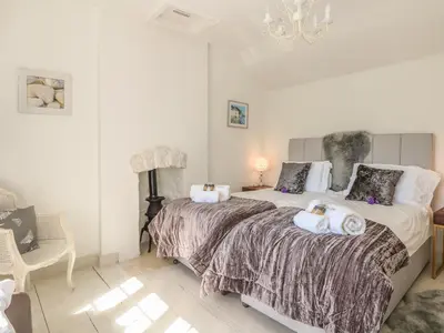 a bedroom with two beds with towels on them at Sea Cliff Cottage in Pentewan