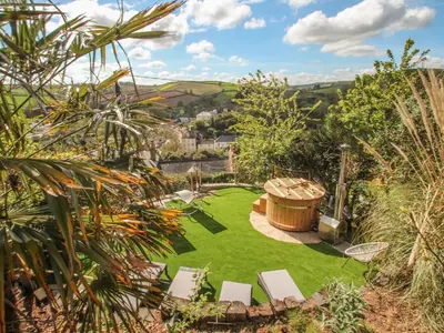 an aerial view of a garden with a hot tub at Sea Cliff Cottage in Pentewan