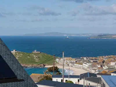 a view of a city and the ocean from a building at Godrevy in St Ives