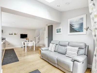 a living room with a couch and a table at The Beach House in Crantock