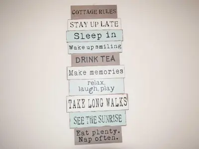 a white sign with different words on a wall at Bay View House in Crantock