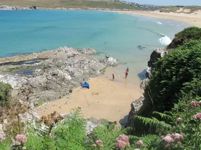 a group of people on a beach near the ocean at Bay View House in Crantock