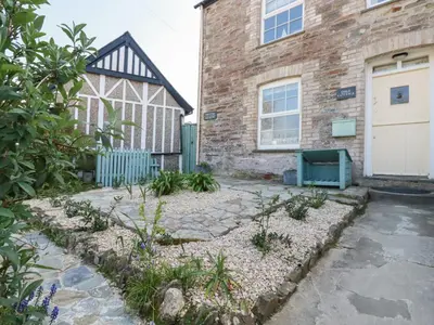 a garden in front of a brick building at Dale Cottage in Crantock