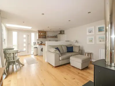 a living room with a couch and a table at The Bolthole in Crantock
