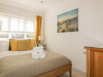 a bedroom with a bed with towels on it at Offshore in Newquay
