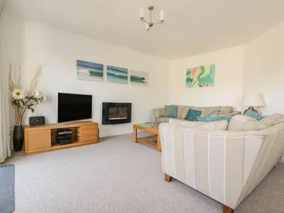 a living room with a couch and a tv at Offshore in Newquay