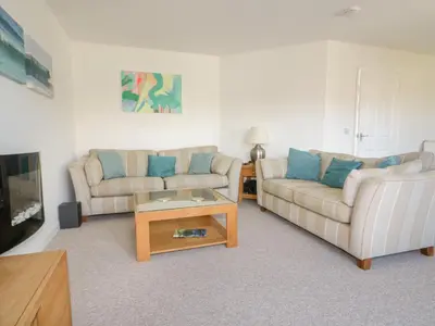 a living room with two couches and a coffee table at Offshore in Newquay
