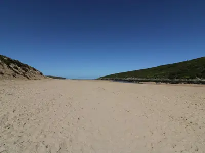 a sandy beach with footprints in the sand at Crantock Bay House in Crantock