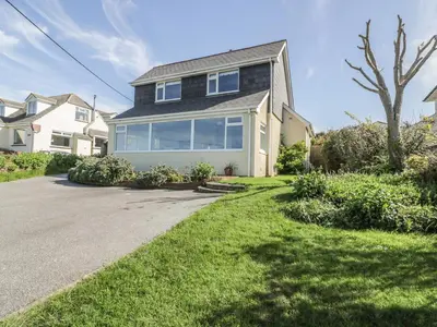 a large house with a driveway in the yard at Crantock Bay House in Crantock