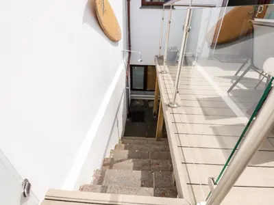 a staircase leading up to the basement of a house at The Dunes in Crantock