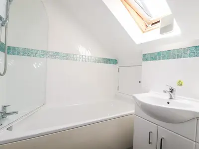 a bathroom with a sink and a tub and a shower at The Dunes in Crantock