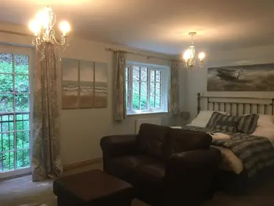 a living room with a couch and a bed at The Waterwheel in St Austell