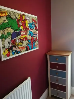 a bedroom with a dc comics poster on the wall at Roselyn House in Par