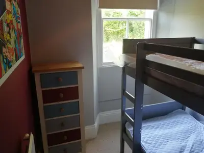 a small bedroom with a bunk bed and a dresser at Roselyn House in Par