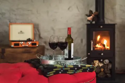 a bottle of wine and two glasses on a table at The Hideaway & Spa Terrace at Tregoose Old Mill in Newquay