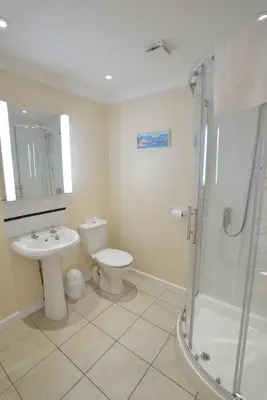 a bathroom with a toilet and a sink and a shower at The Penellen guest accommodation room only in Hayle