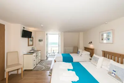 a hotel room with two beds and a television at The Penellen guest accommodation room only in Hayle